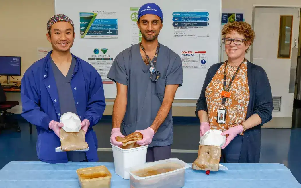 Anaesthetists Jeremy Young and Raj Palepu with Melita Macdonald, the manager of Wellington Regional Hospital's simulation service, and the scoby. Photo: Te Whatu Ora - Health New Zealand